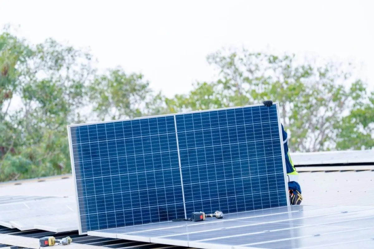 worker installing solar panel