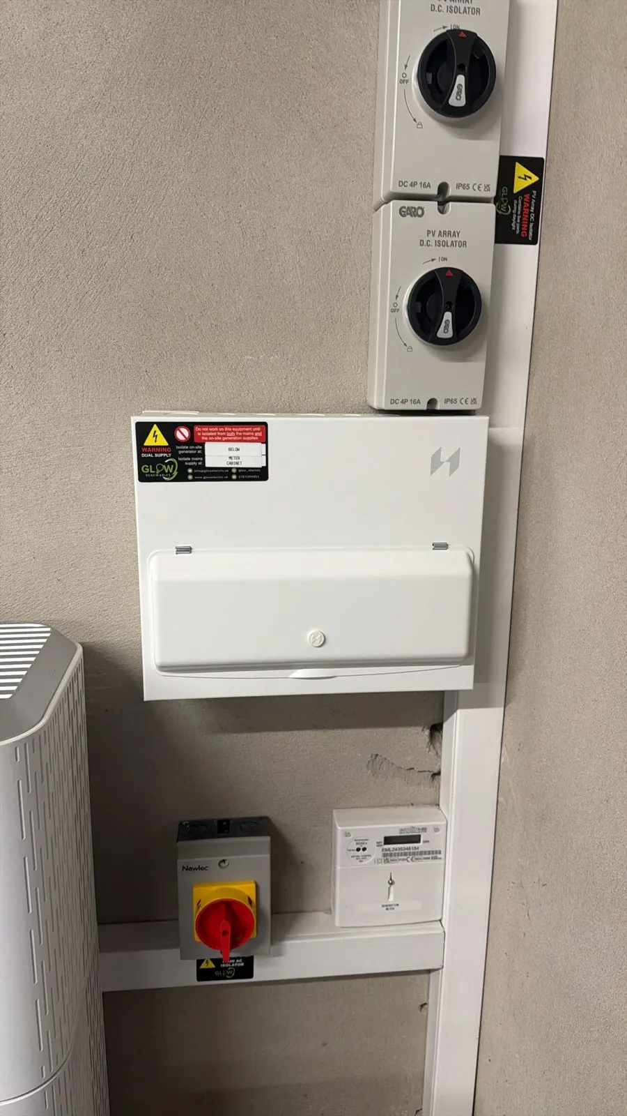 Dual-supply consumer unit with PV isolators and generation meter, installed and labelled by Glow
