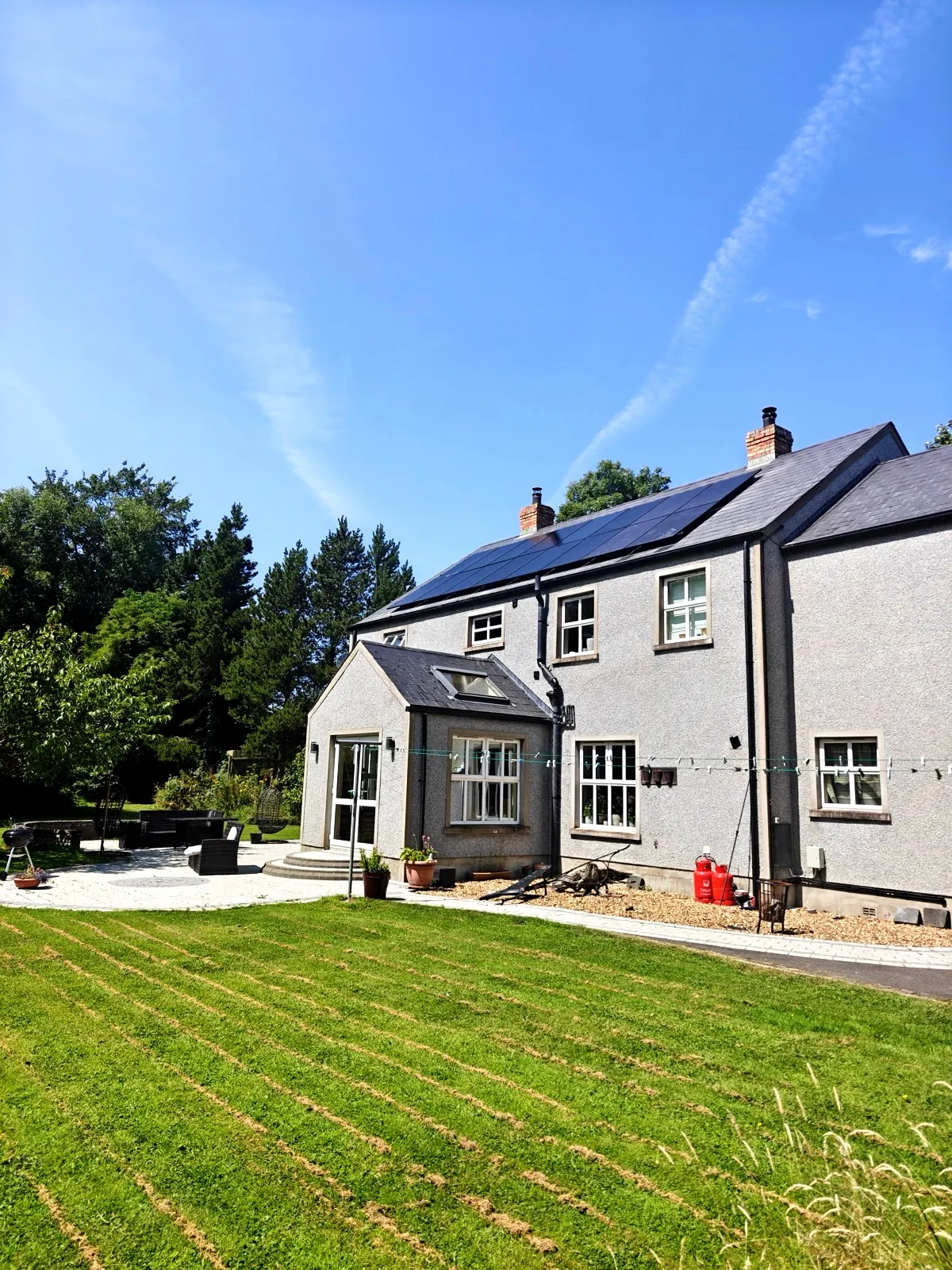 All-black solar array installed by Glow on a rendered home in Antrim, Northern Ireland