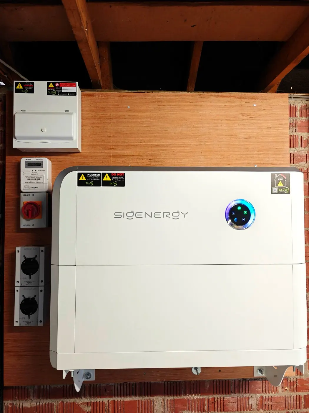 Sigenergy SigenStor wall-mounted in a garage — Glow install