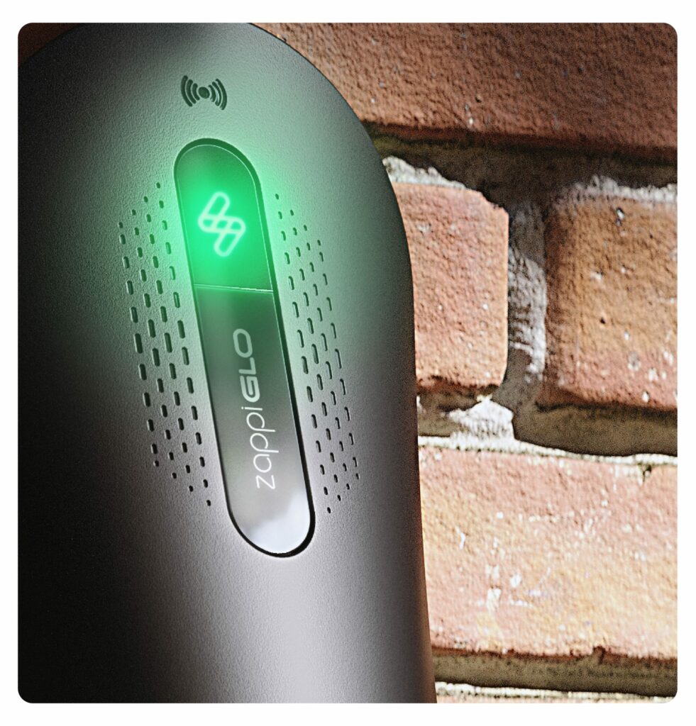 Close-up of the black myenergi Zappi GLO charger with its green status light